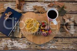 Overhead view of food with coffee cup on wooden tray