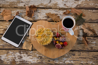 Food with coffee cup on wooden tray by tablet computer