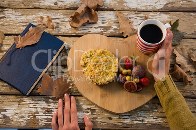 Cropped hand of woman having food