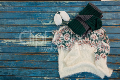 Directly above shot of warm clothes with gloves and ear muffs