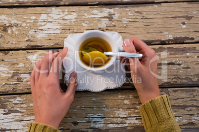 Cropped hands of woman with tea