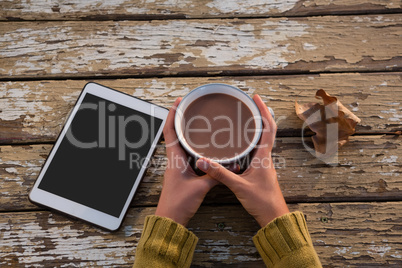 Cropped hand on woman having coffee