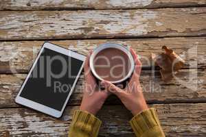 Cropped hand on woman having coffee