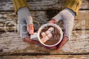 Cropped  hand of woman having hot chocolate