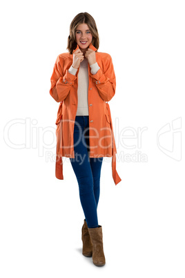 Full length of portrait of happy woman wearing warm clothing