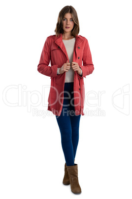 Full length of portrait of young woman wearing warm clothing