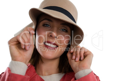 Close up portrait of young woman holding hat
