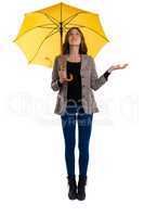 Full length of woman holding umbrella while gesturing