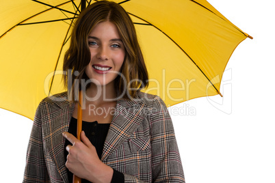 Portrait of young woman holding umbrella