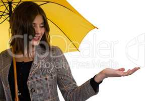 Young woman holding umbrella while gesturing
