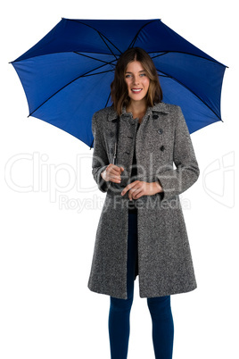 Portrait of smiling young woman holding umbrella Portrait of smiling young woman holding umbrella