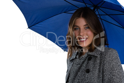 Portrait of smiling woman with blue umbrella