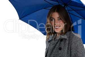 Portrait of smiling woman with blue umbrella