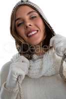 Portrait of smiling woman holding knit hat