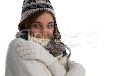 Portrait of young woman hugging self