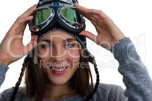 Portrait of smiling woman holding with ski goggles