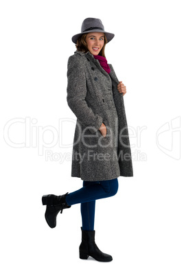 Portrait of smiling young woman with hands in pockets