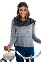 Portrait of woman standing by bicycle