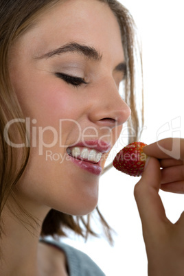 Close up of woman eating strawberry