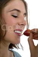 Close up of woman eating strawberry