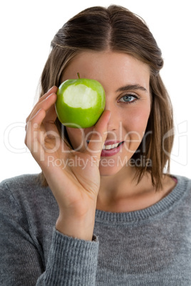 Portrait of woman holding granny smith apple