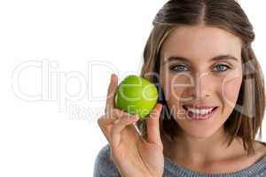 Portrait of smiling woman holding granny smith apple