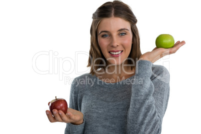 Portrait of young woman showing apples