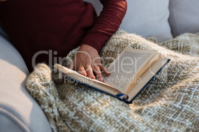 Mid section of woman with book