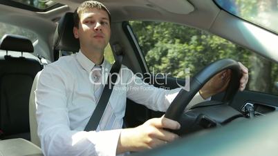 Confident businessman driving car in countryside