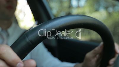 Man hands holding steering wheel while driving car
