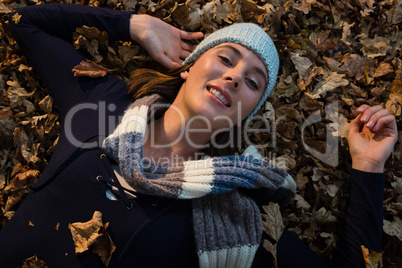 Overhead view of woman lying on dry leaves