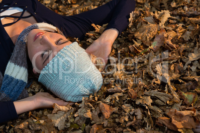 High angle view of woman lying on dry leaves
