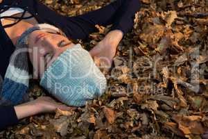 High angle view of woman lying on dry leaves