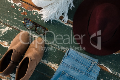 High angle view of shoe and jeans with personal accessories