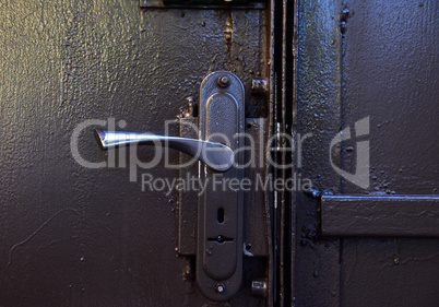 Iron door handle on iron gray doors