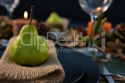 Close up pf pear served on burlap in plate