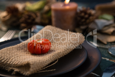 Close up of tomato on burlap in plate