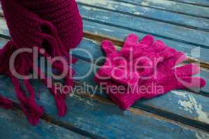 High angle view of pink muffler with gloves