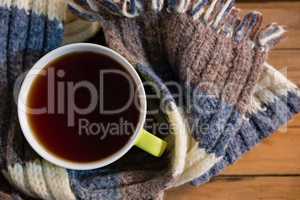 Overhead view of black coffee amidst scarf