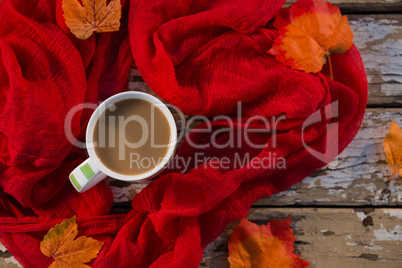 Overhead view of coffee cup amidst scarf