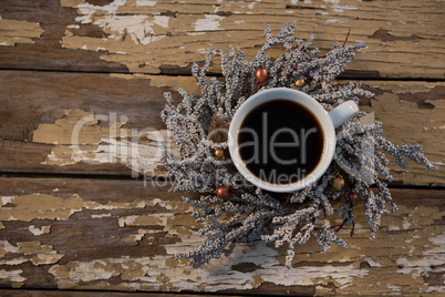 Overhead view of black coffee on dried plant