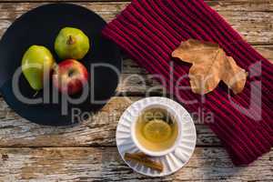 High angle view of lemon tea by fruits in plate