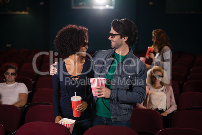 Couple looking at each other movie in theatre