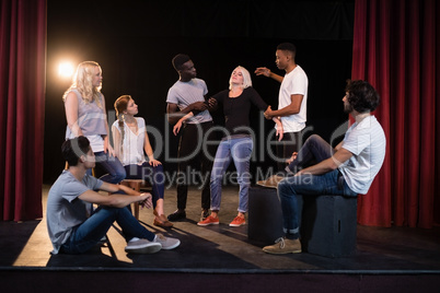 Actors practicing play on stage
