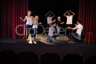 Actors practicing play on stage