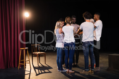 Actors team forming their hands stacked