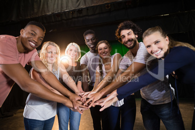 Actors team forming their hands stacked