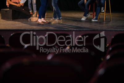 Actors practicing play on stage in theatre