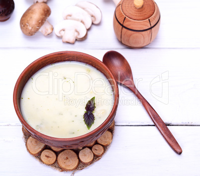 Creamy mushroom soup in a brown round plate