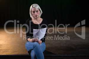 Actress reading her scripts on stage